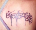 Indian lady with tattoo on upper back
