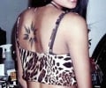 indian girl shows of her back tattoos