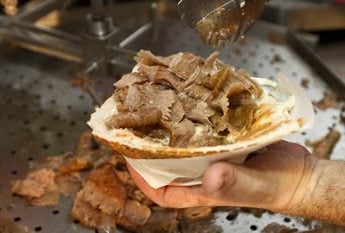 Beautiful young girl with delicious doner donair kebab in her head