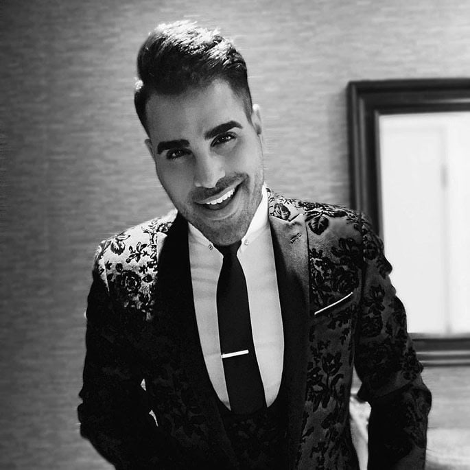 Ranj Singh smiling and wearing a suit