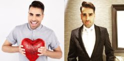 College of Dr Ranj Singh holding a heart and wearing a suit