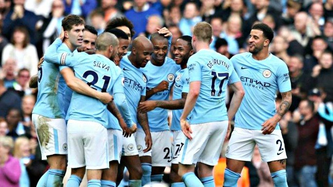 Manchester City players celebrate scoring one of their 38 Premier League goals