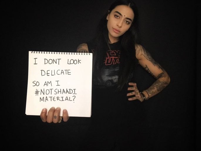 Bani J holding a sign