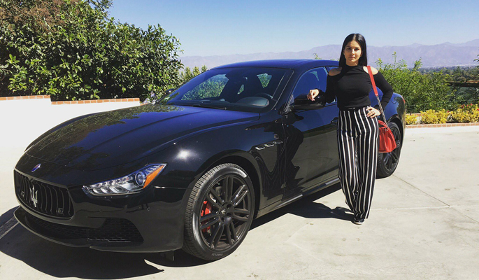 Sunny Leone standing next to her car