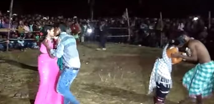 Couples kiss in front of crowds