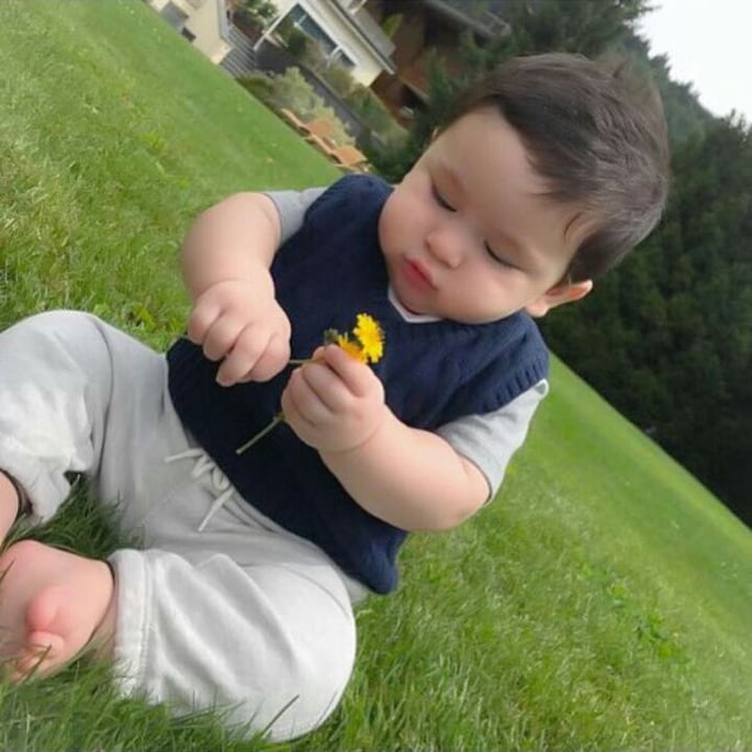 Taimur playing with a flower