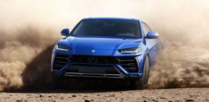 Lamborghini Urus racing through a dirt road